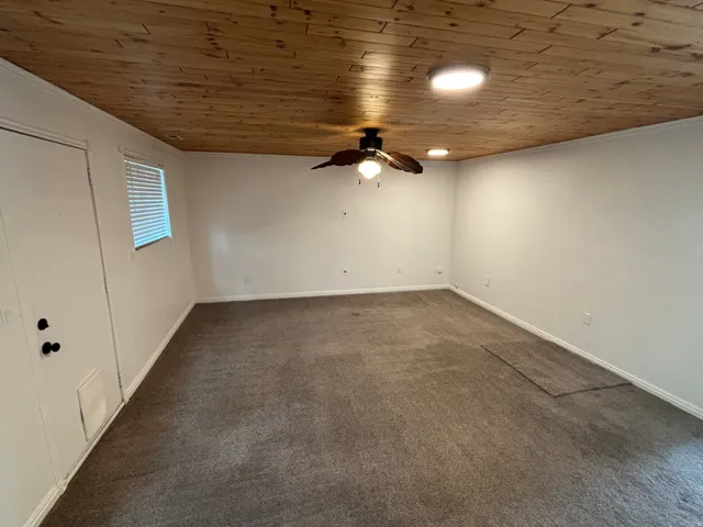 Wood-paneled ceiling with recessed lighting and a ceiling fan