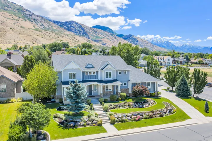 Two-story property with light blue siding and stone accents