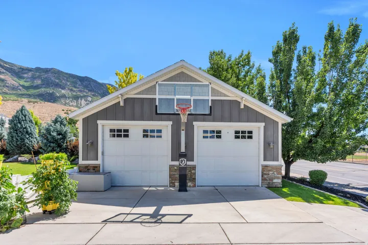 Two-car garage with white paneled doors and window accents