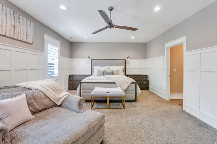 Bedroom featuring board and batten wainscoting, recessed lighting, and a ceiling fan