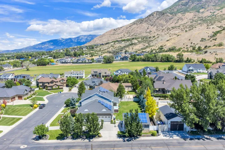 Residential neighborhood with mature landscaping and mountain scenery