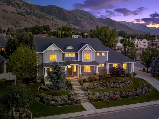 Expansive two-story residence featuring a multi-gabled roofline and a mixed material exterior