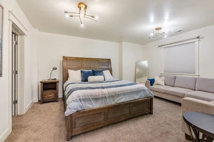 Spacious room featuring neutral carpeting and white painted walls