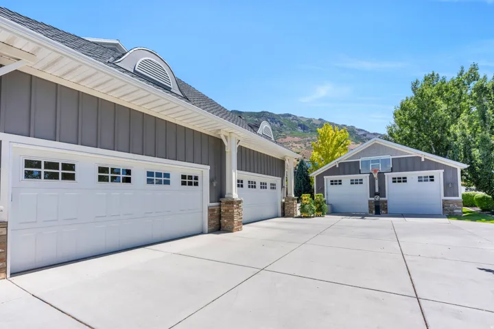 Expansive concrete driveway servicing multiple garage doors