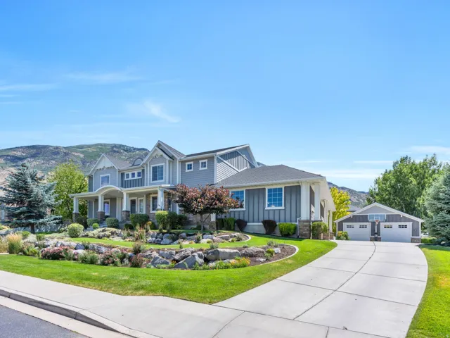 Spacious residence featuring a multi-gable roofline, two-car attached garage, and a detached two-car garage