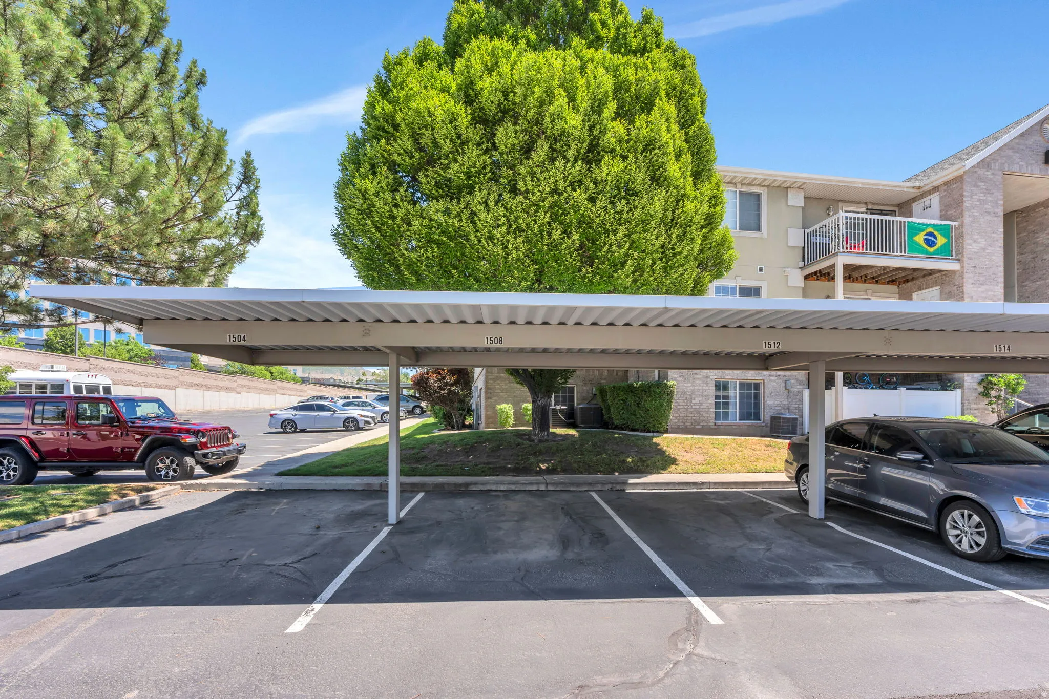 One Covered parking structure with individual numbered spaces