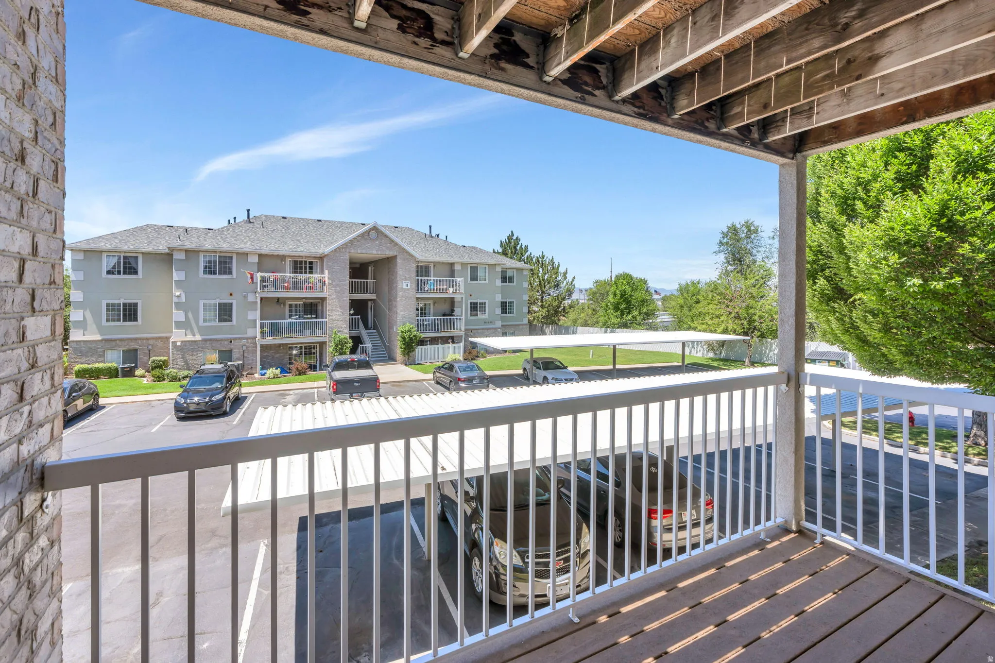 Private balcony featuring a wood-finish floor and white railings