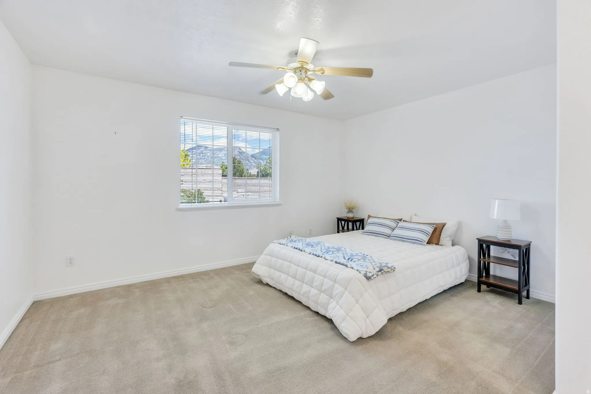#2 Bedroom--Bright  with neutral carpeting and a ceiling fan light fixture