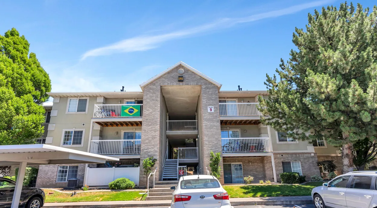 Three-story multi-unit dwelling featuring a brick and stucco exterior