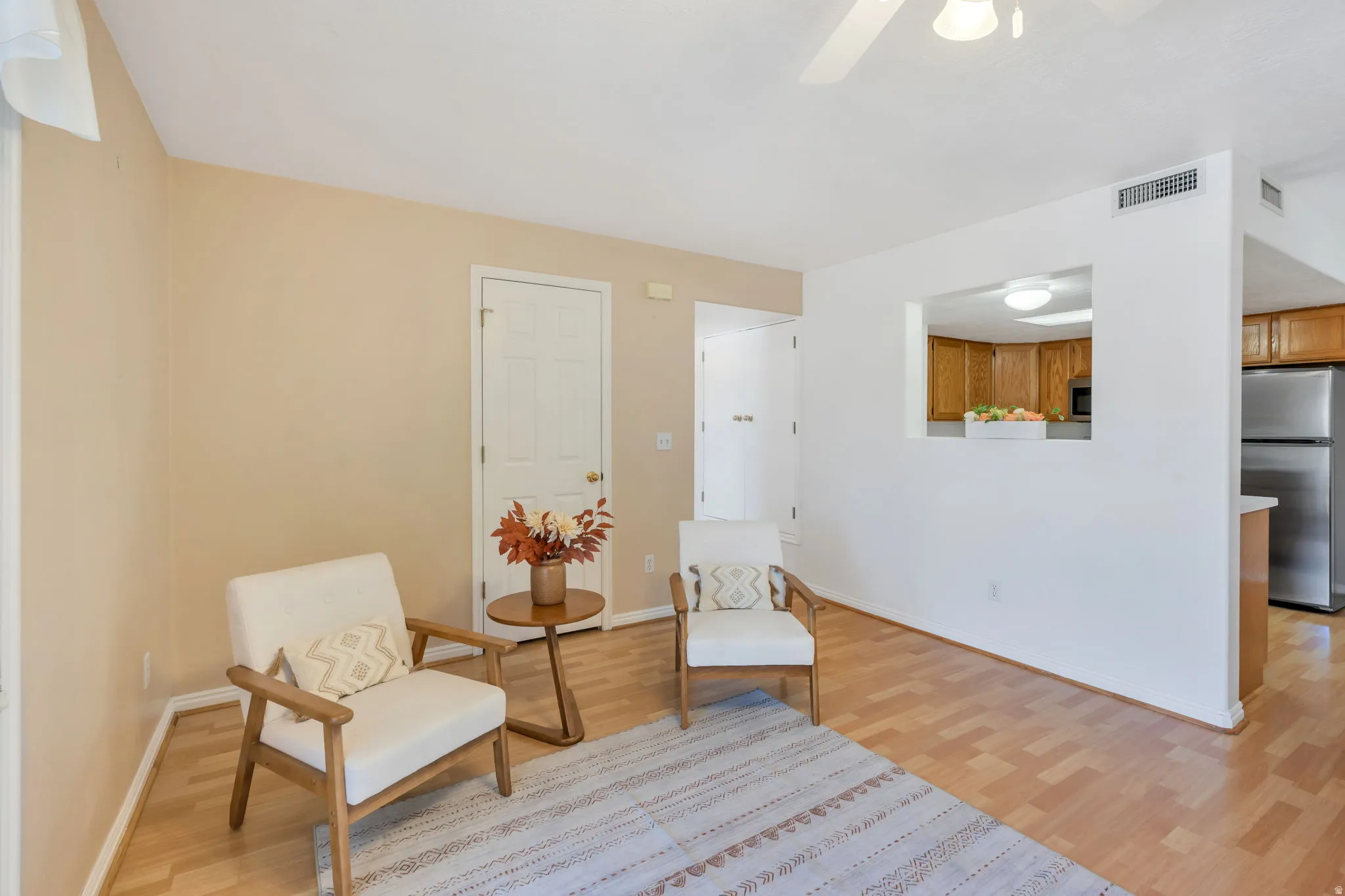 Living area featuring wood-finish flooring and a ceiling fan