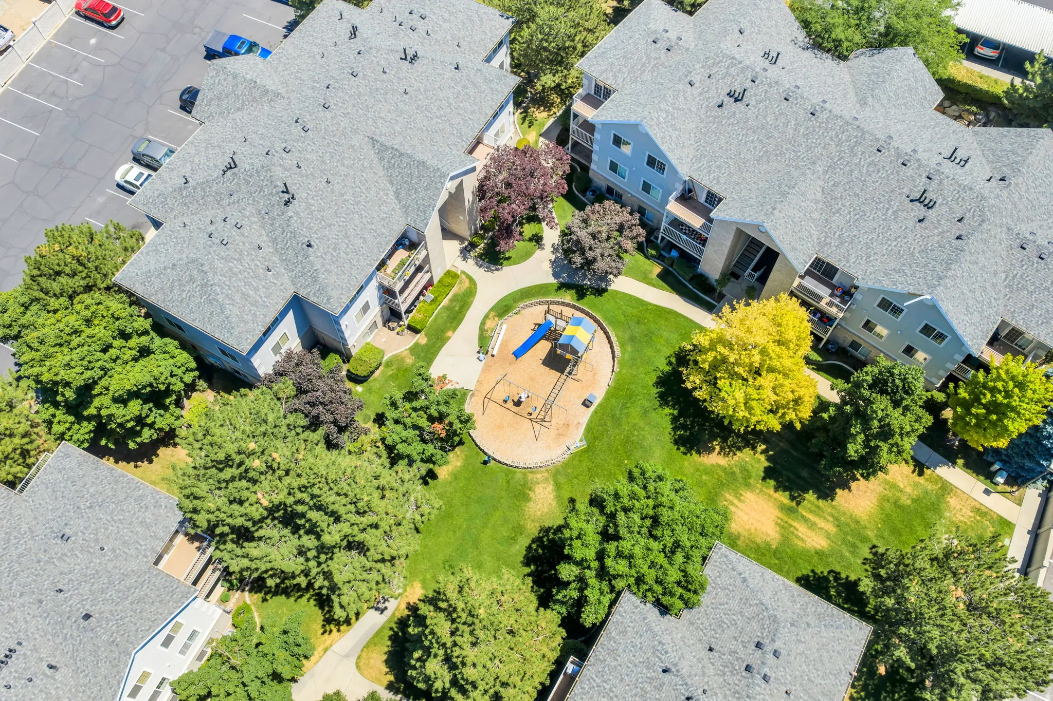 Aerial perspective of Central courtyard featuring a playground and surrounded by manicured green lawn and mature trees
