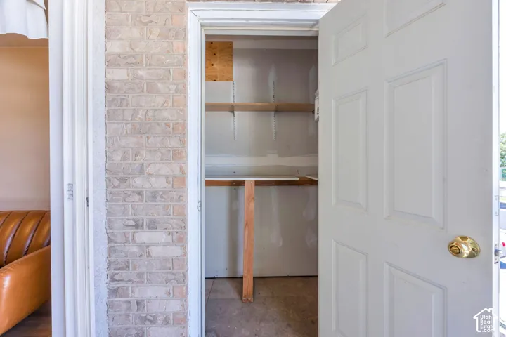 Storage area on Balcony  featuring built-in wood shelving