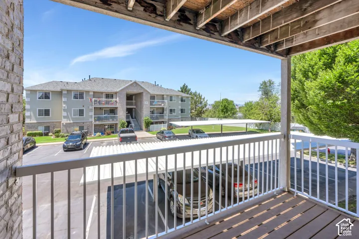 Private balcony featuring a wood-finish floor and white railings