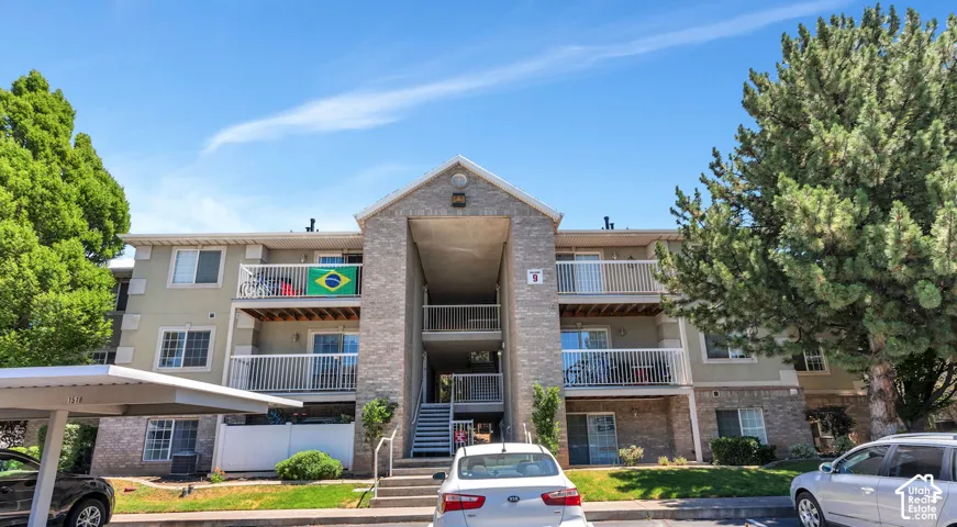 Three-story multi-unit dwelling featuring a brick and stucco exterior