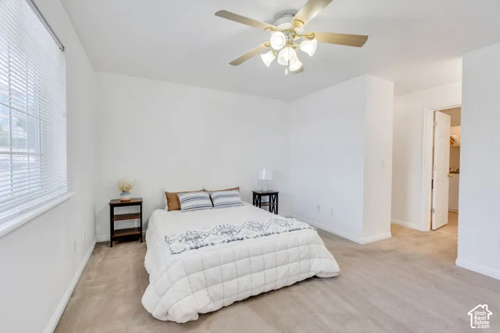#2 Carpeted room featuring a ceiling fan with integrated lighting, a window with horizontal blinds, and a white paneled door