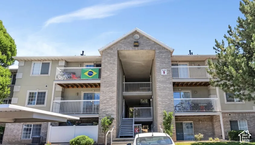 Multi-story building featuring light brick and stucco exterior