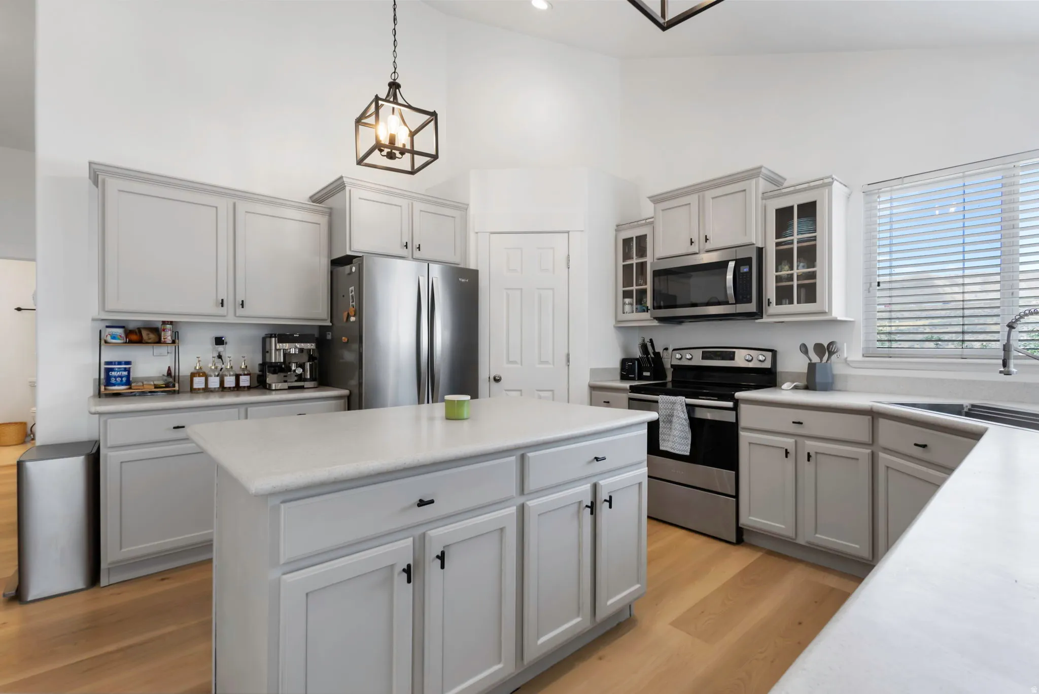 Kitchen featuring light wood-finish flooring and vaulted ceilings