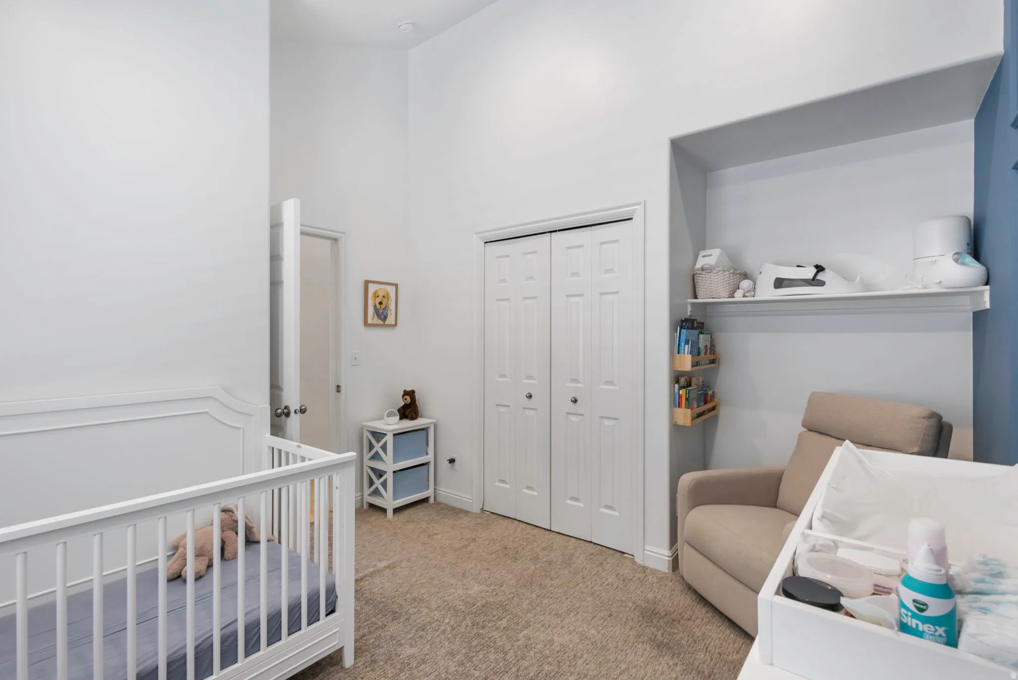 Room featuring neutral wall tones, textured carpeting, and a vaulted ceiling