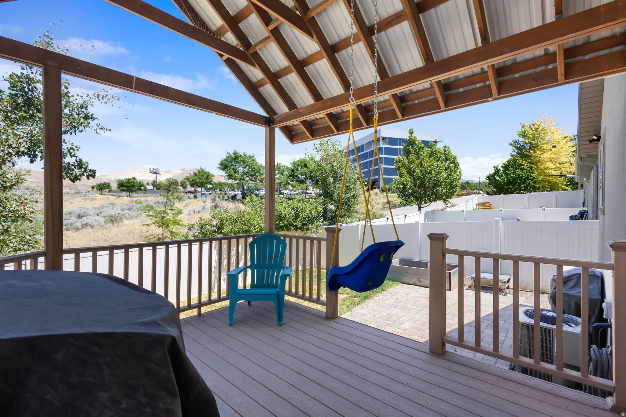 Covered deck featuring wood-finish flooring, exposed beam ceiling, and metal roofing