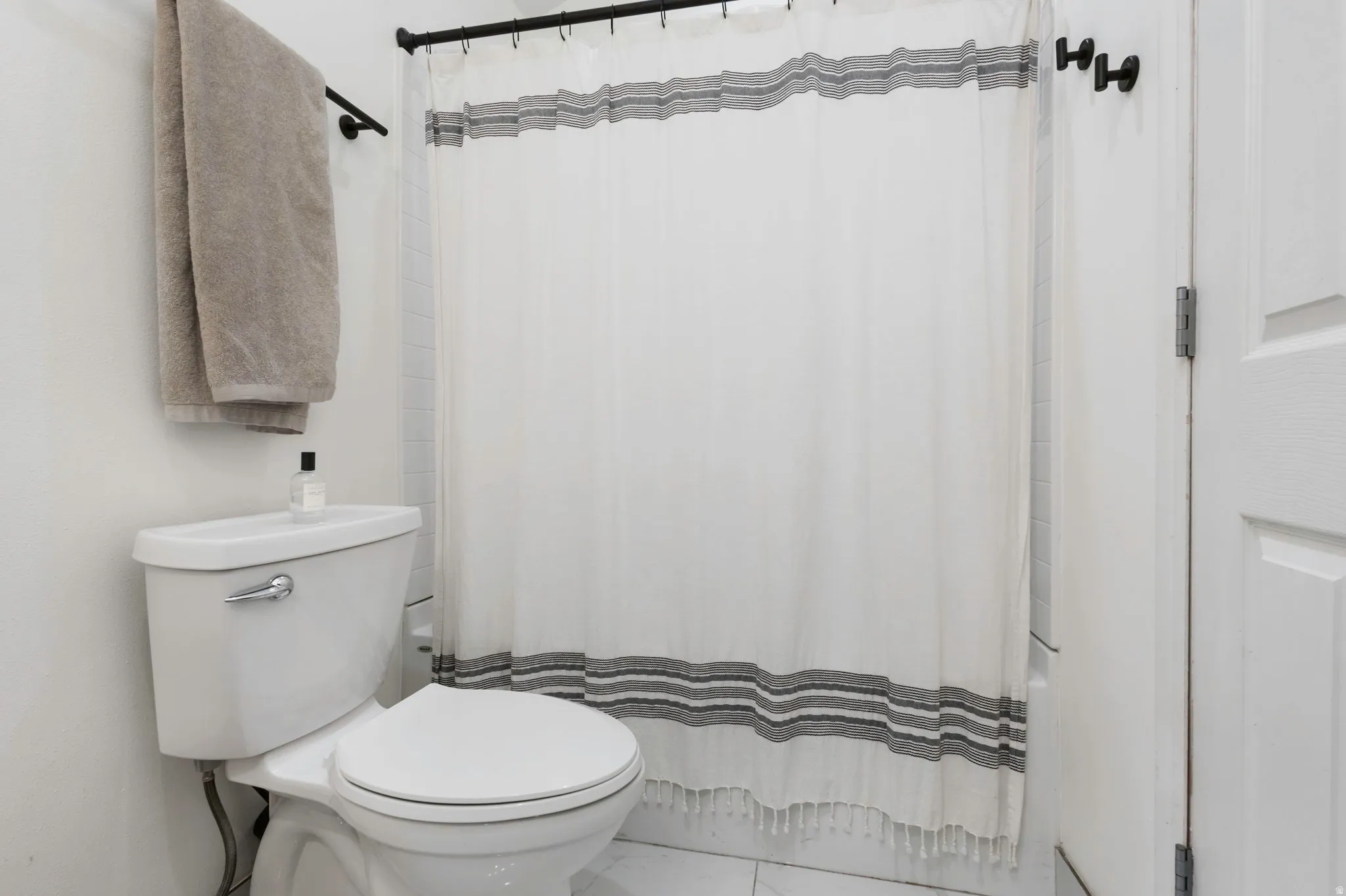 White toilet with chrome flush lever