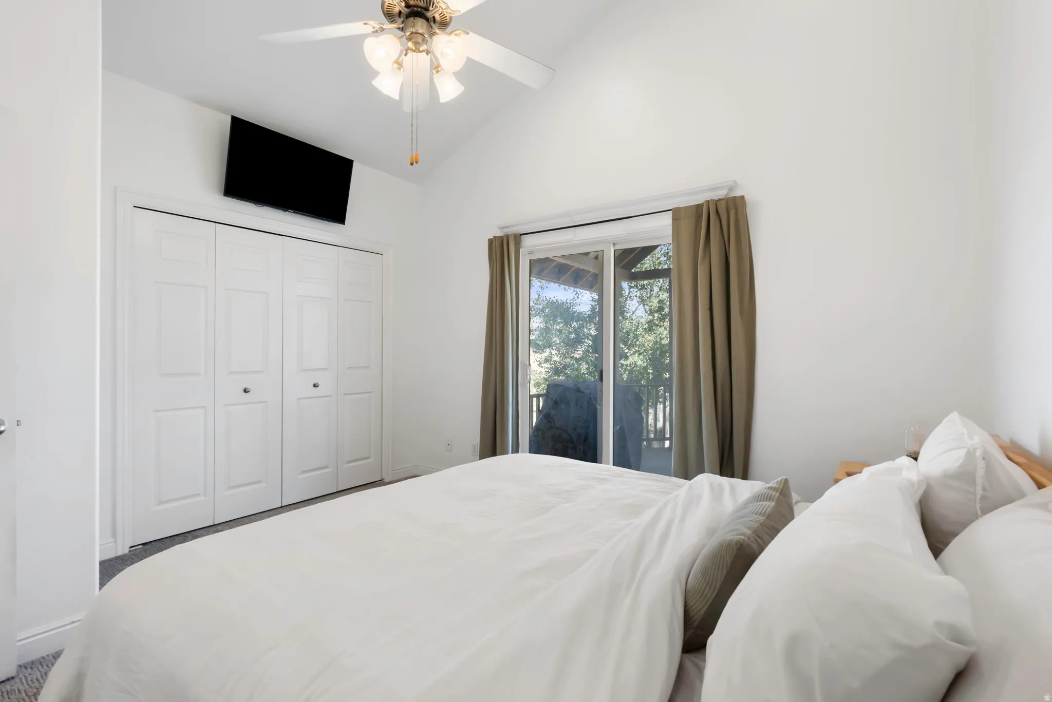 Vaulted ceiling with an overhead fan and light fixture