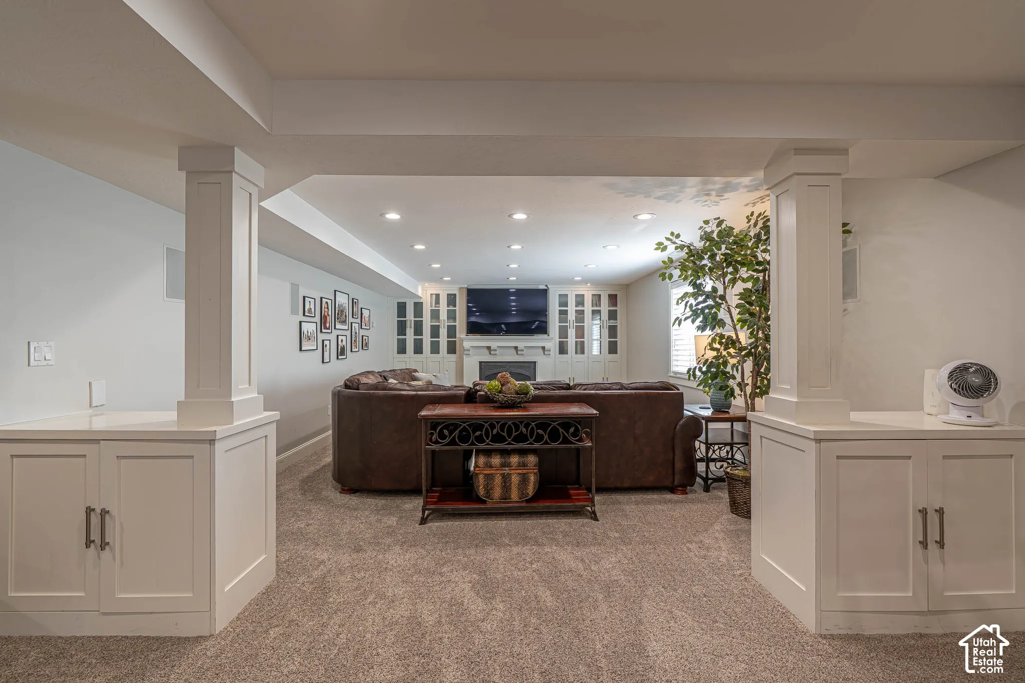 Finished lower level featuring recessed lighting, plush carpet flooring, white built-in cabinetry, and plenty of room for fun movie nights.