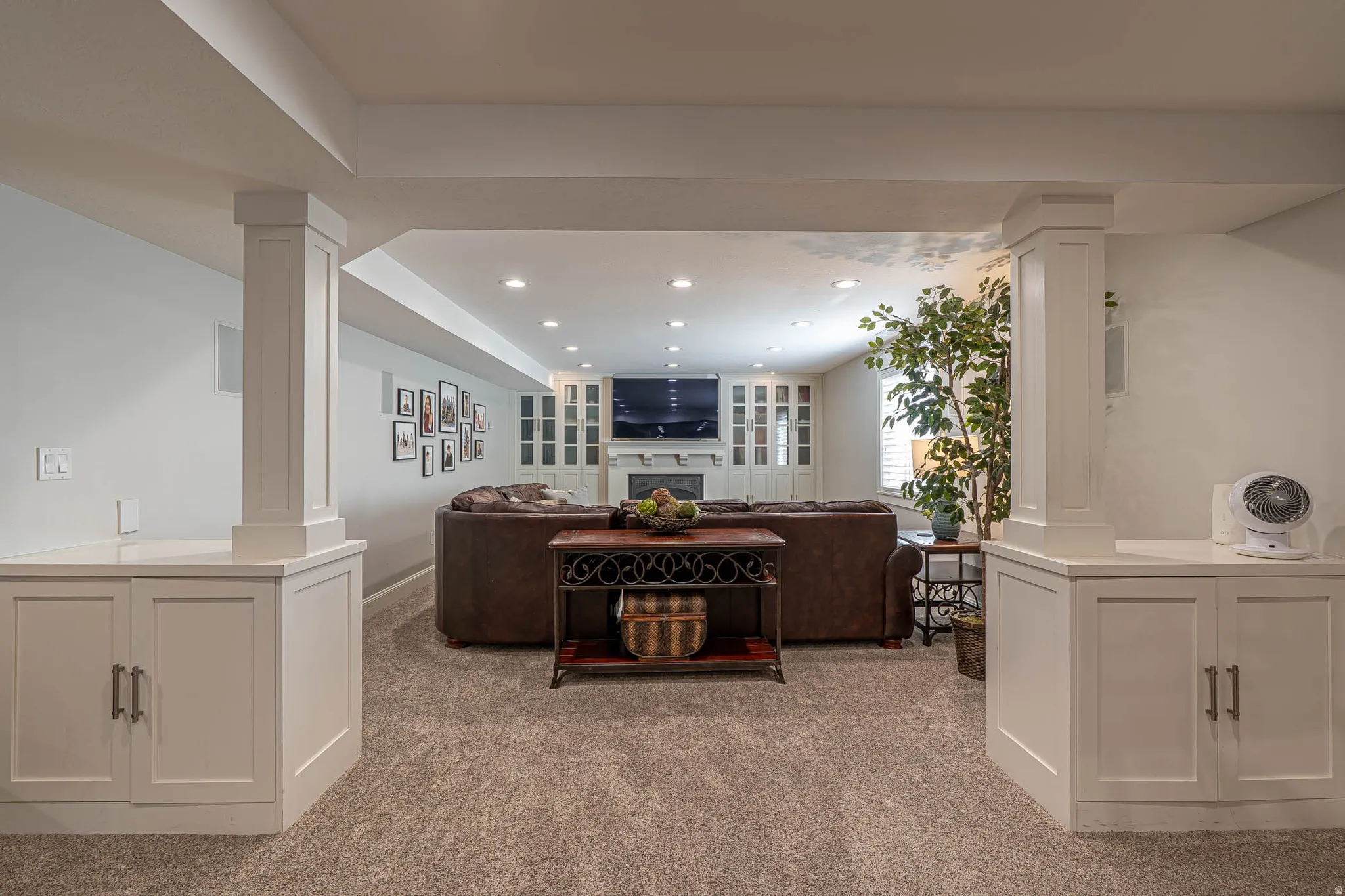 Finished lower level featuring recessed lighting, plush carpet flooring, white built-in cabinetry, and plenty of room for fun movie nights.