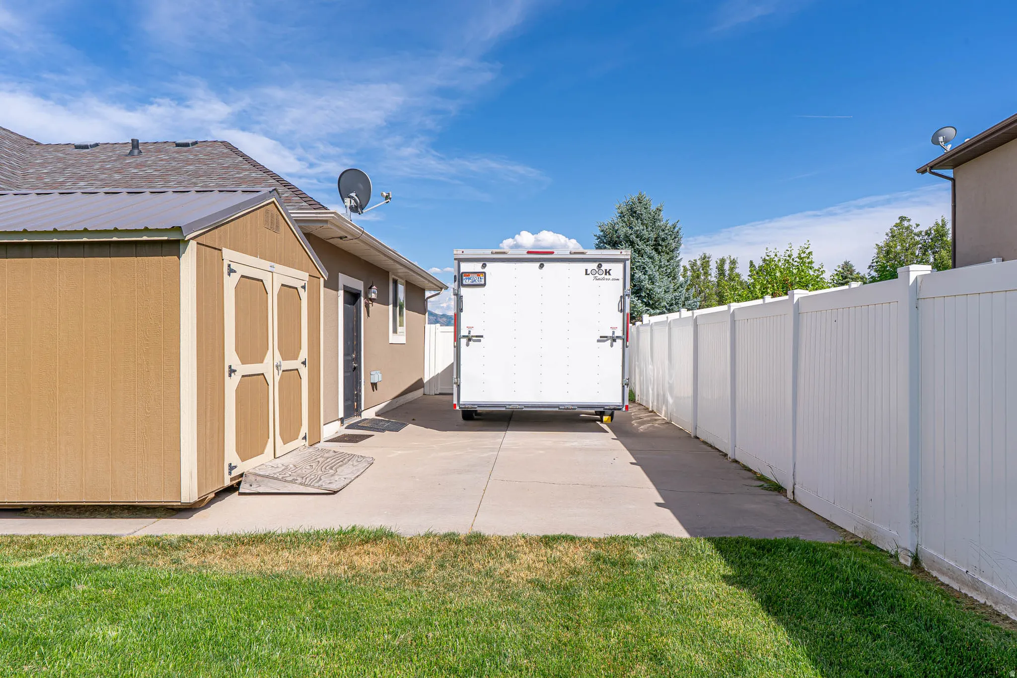 Backyard featuring a dedicated concrete drive, for a trailer, boat, or all of your toys.
