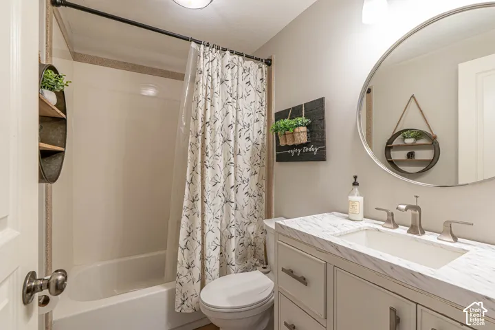 Adorable bathroom featuring a vanity with a white countertop and rectangular undermount sink