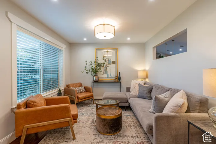 Living space featuring a large window with natural lighting, recessed lighting, and a drum-style ceiling fixture
