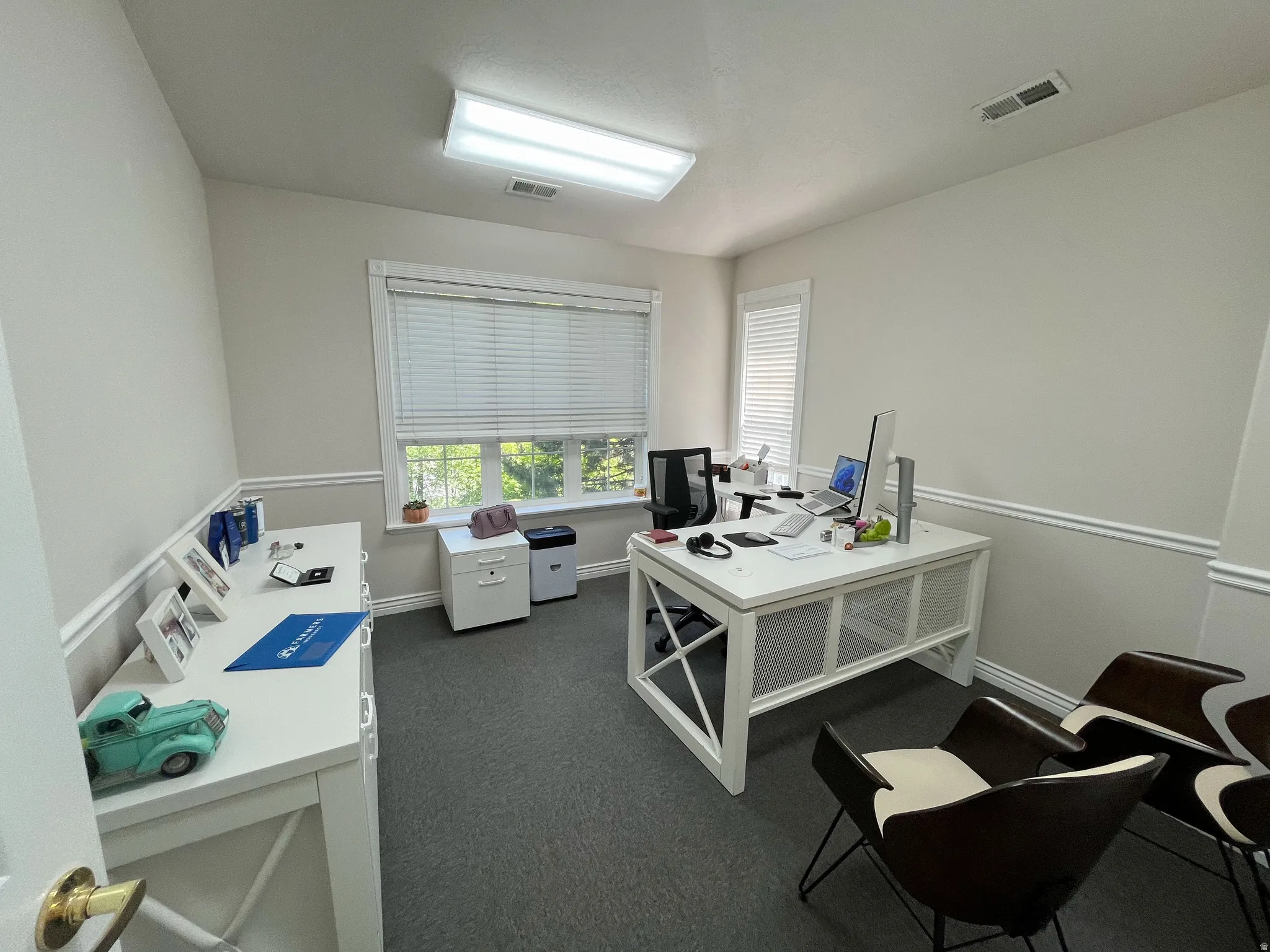 Interior room with neutral wall paint and grey carpeting