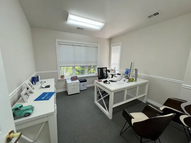 Interior room with neutral wall paint and grey carpeting