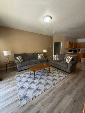 Open-concept living area featuring wood-finish flooring and a neutral color palette