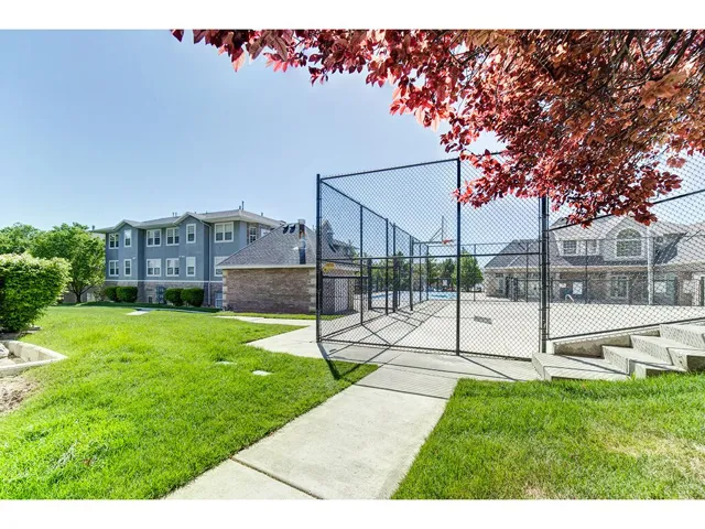 Outdoor recreational area featuring a basketball court and concrete steps