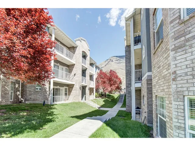 Multi-level residential building featuring brick and stucco siding