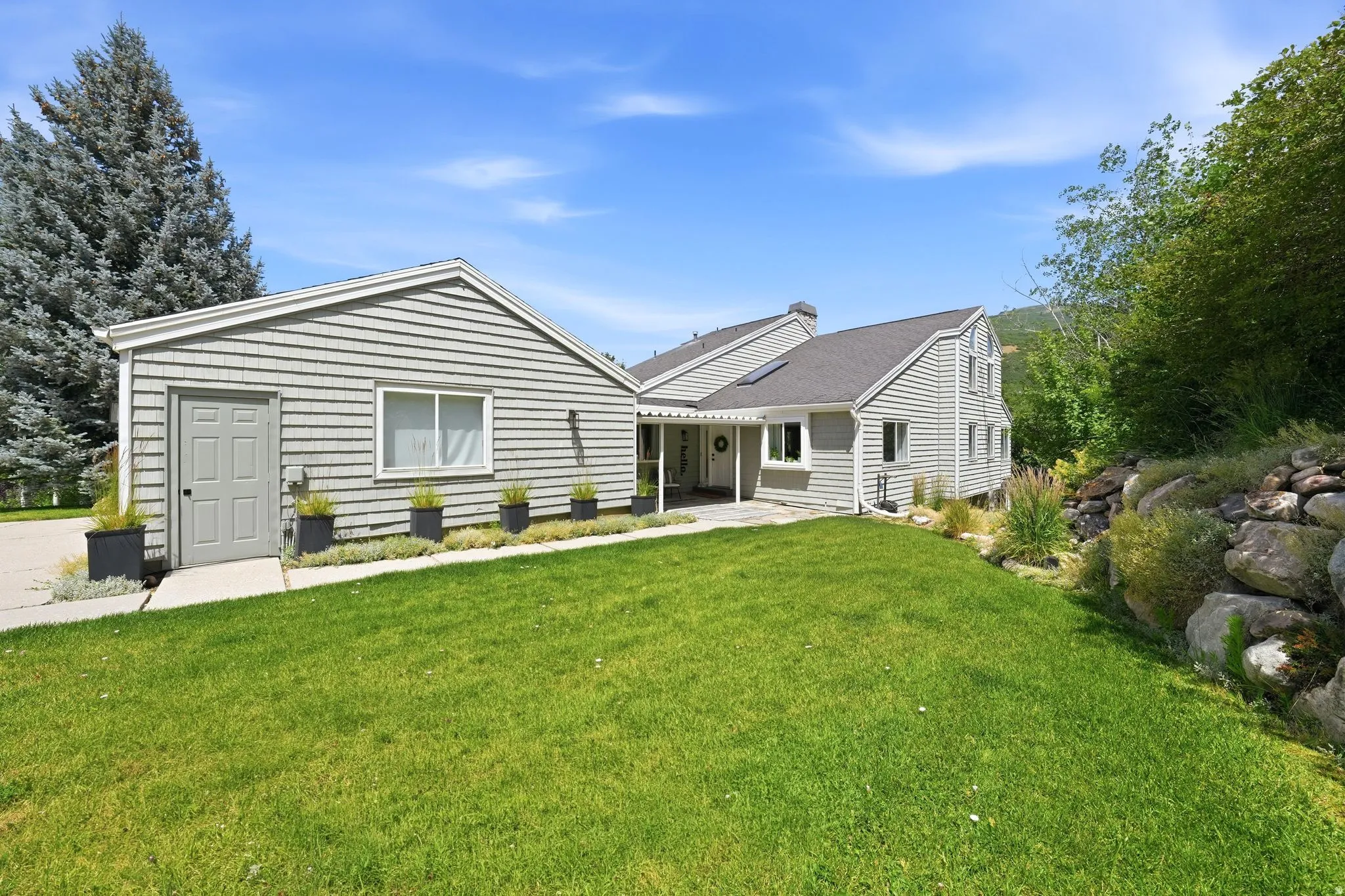Exterior elevation featuring horizontal siding and a dark gray shingle roof