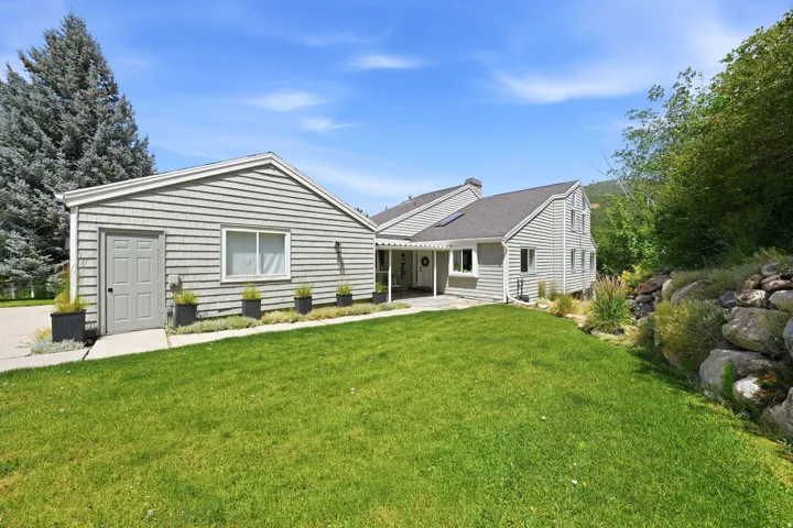 Exterior elevation featuring horizontal siding and a dark gray shingle roof