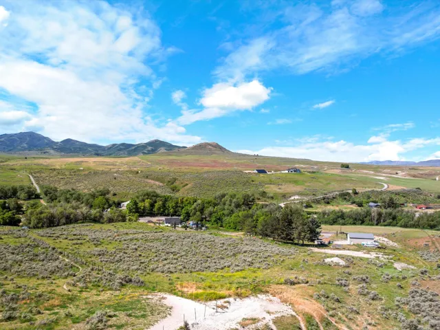 Expansive natural landscape featuring rolling hills and distant mountains