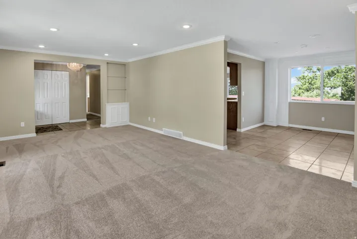 Second view to entry with double closet, built in shelf and view to formal dining