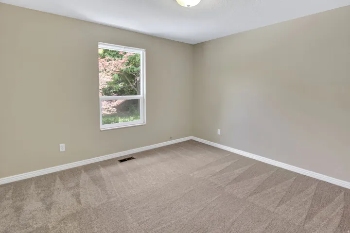 Neutral-toned walls complement plush carpeting