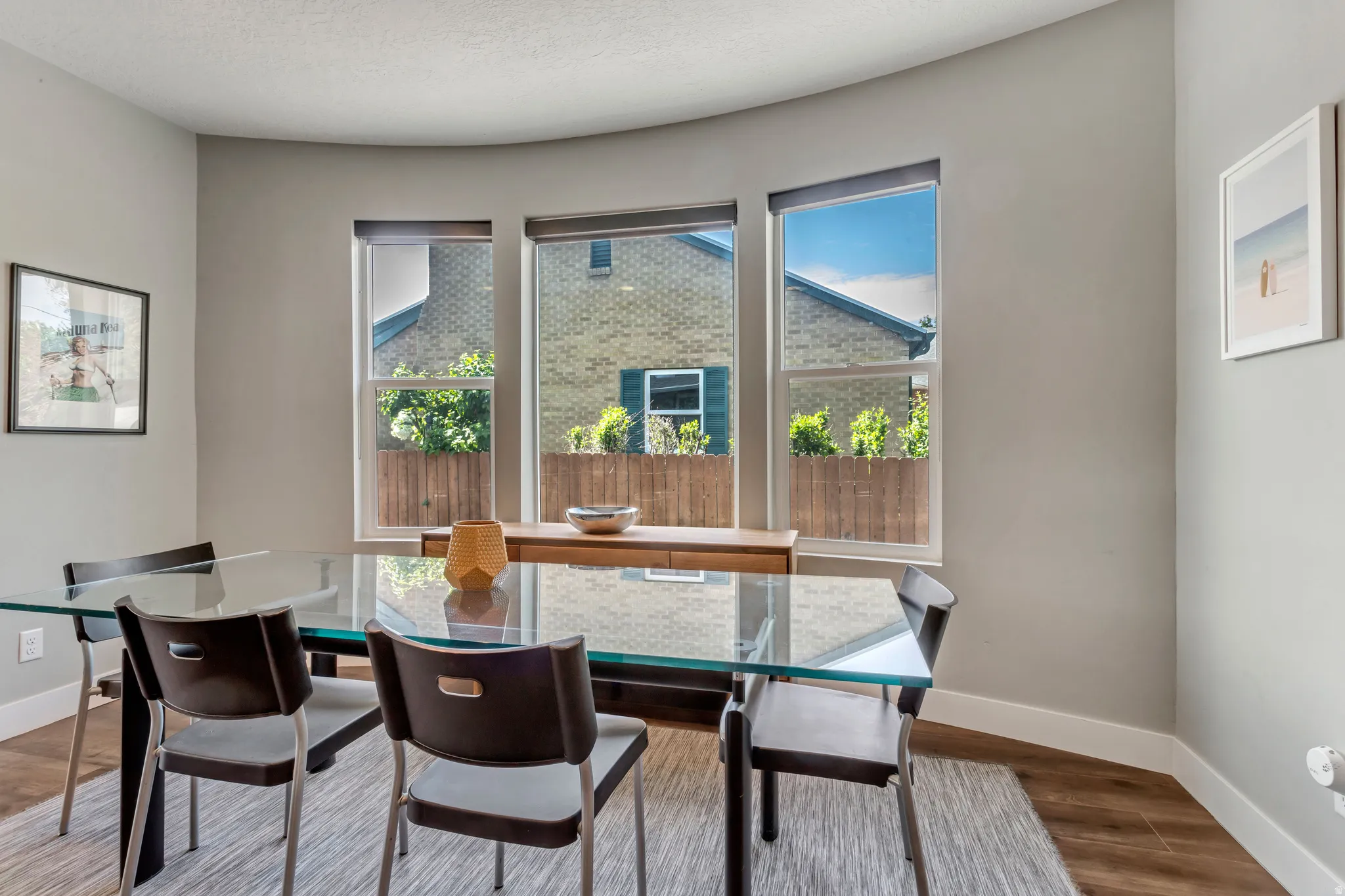 Curved wall with three large windows providing abundant natural light