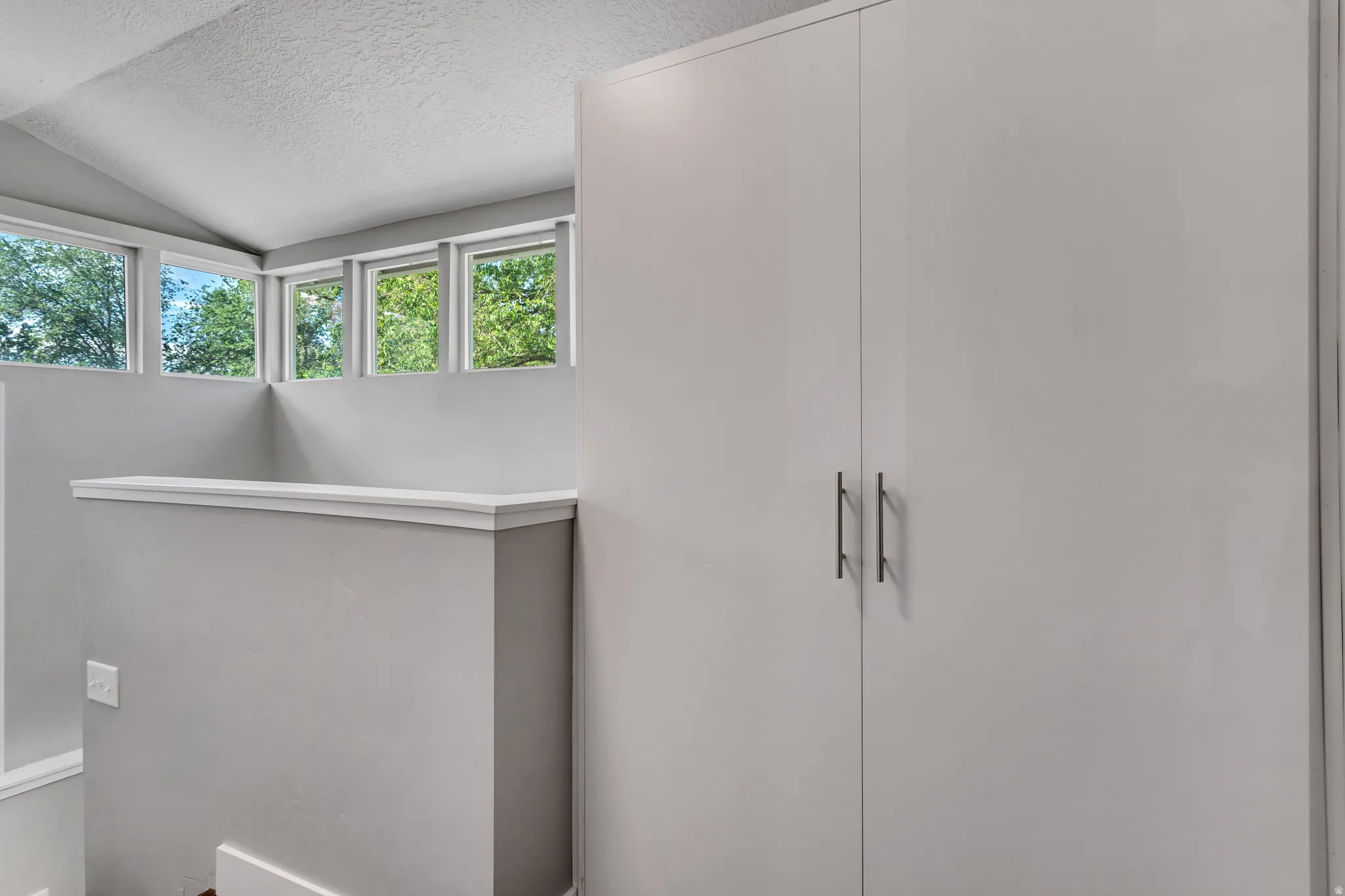 Light gray storage cabinetry featuring contemporary hardware