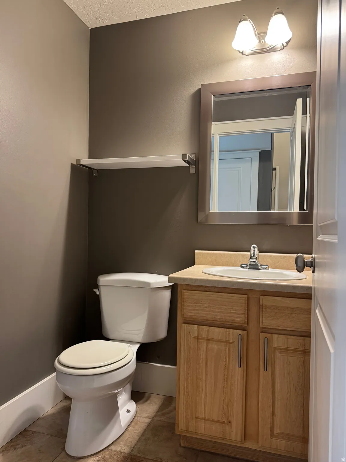 Main floor powder bath features upgraded fixtures and tile floors