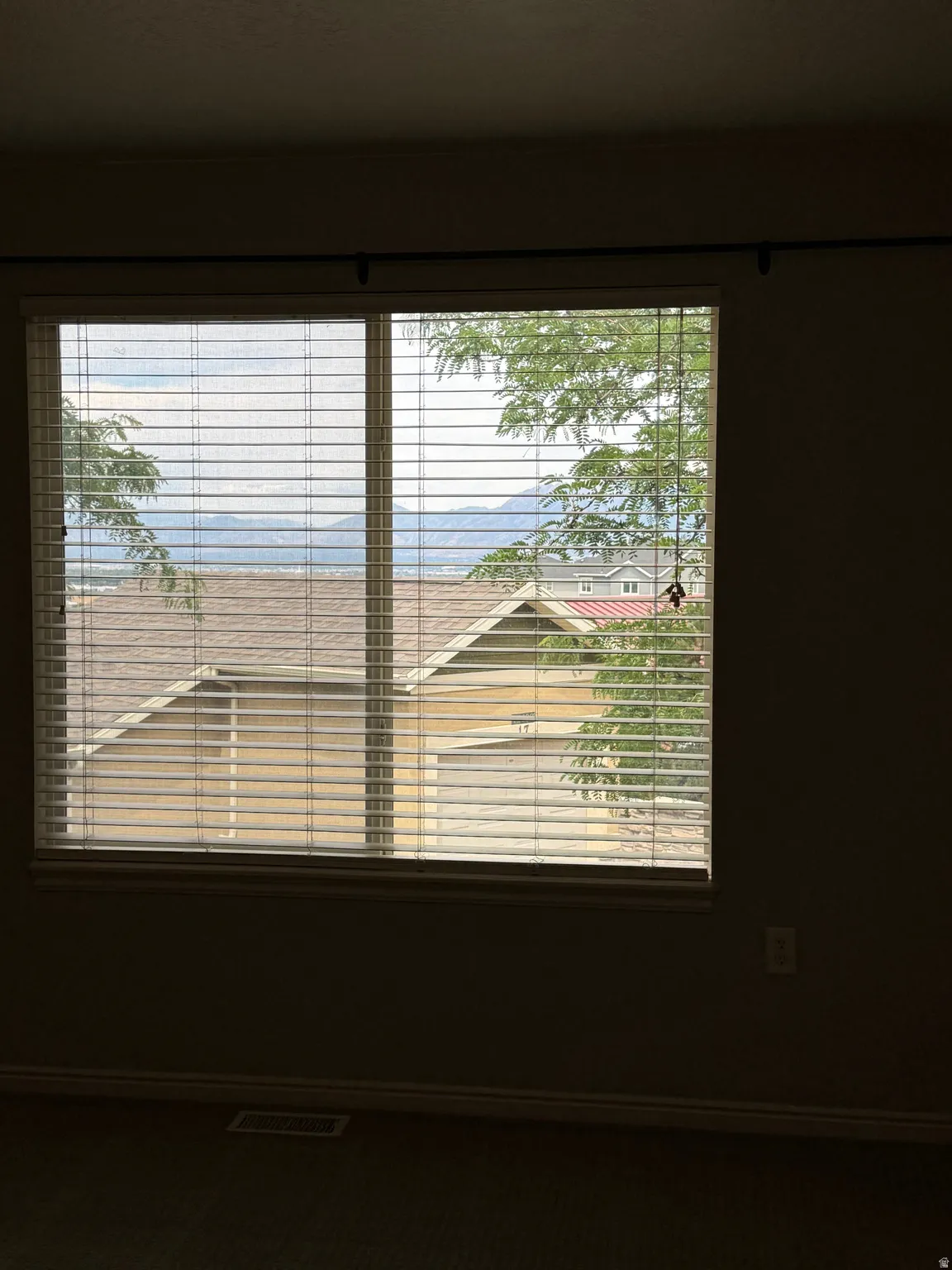View of this home's detached garage from an upstairs bedroom, as well as sweeping valley and mountain views