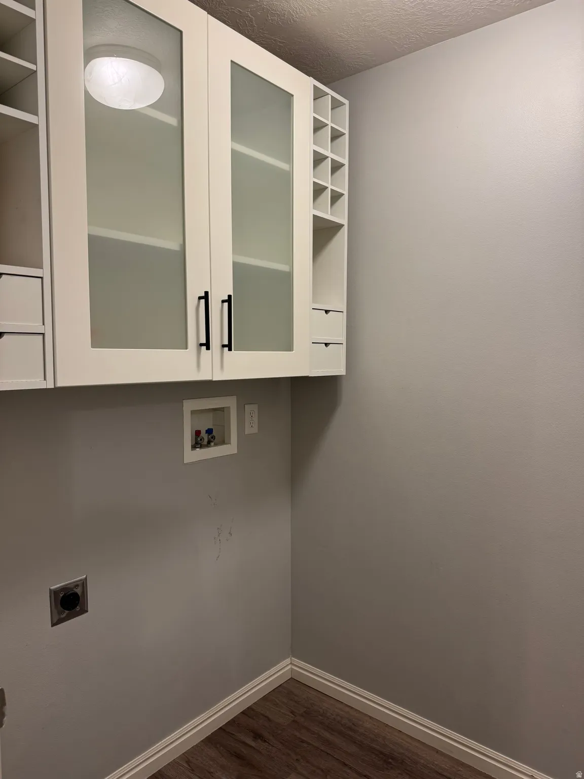 Laundry room with built-in cabinetry and LVP floors
