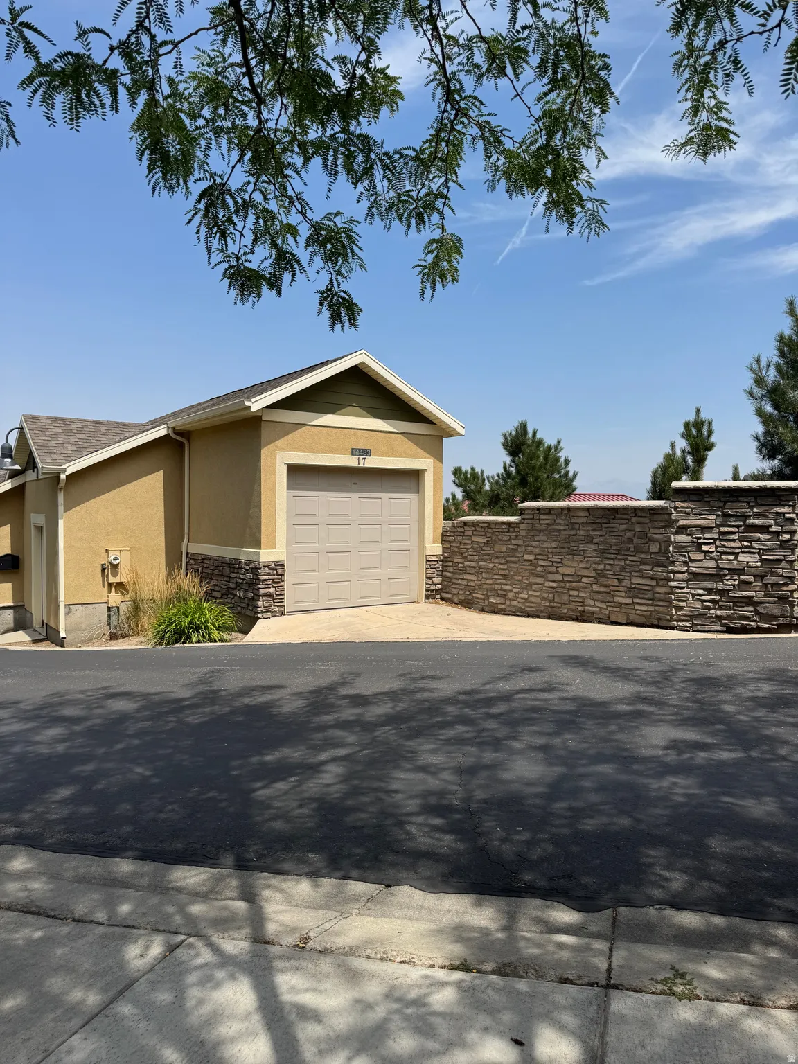 View of the included detached garage from the front porch of the home. This is the only home in the development with ownership of a detached garage