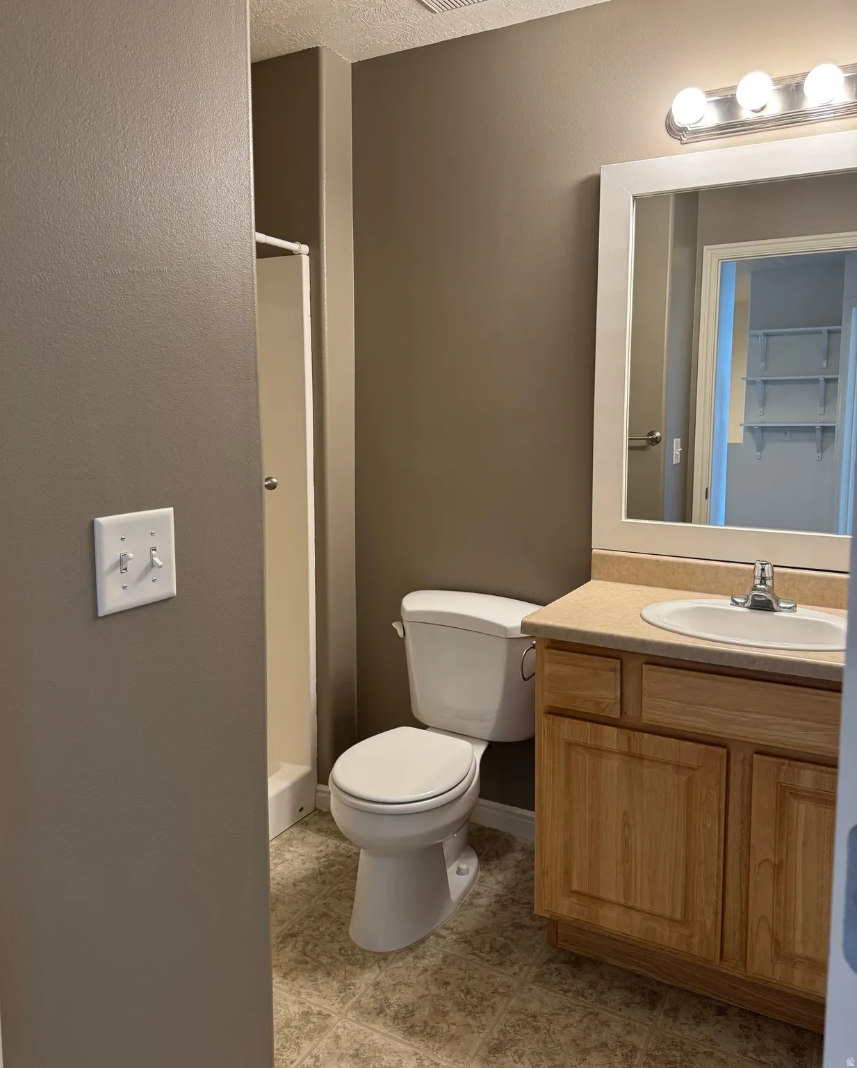 An additional bathroom on the second floor features a built-in vanity and a freestanding shower.