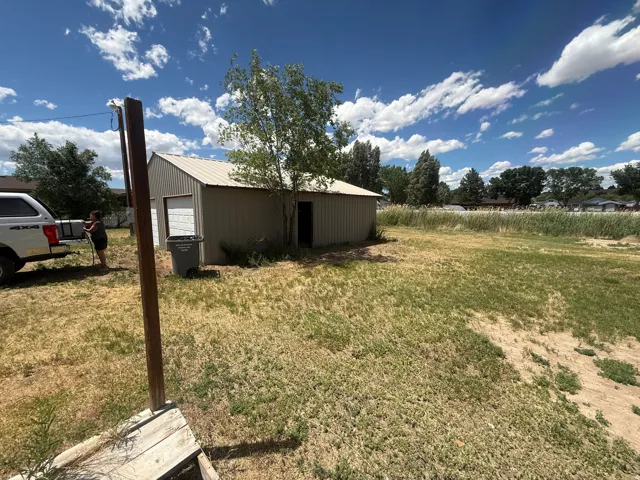 Corrugated metal building featuring a roll-up garage door and an additional entry point