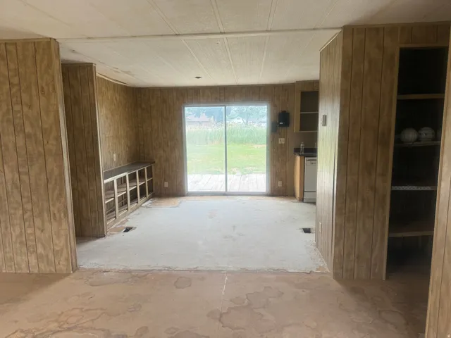 Interior space featuring wood panel walls and a sliding glass door