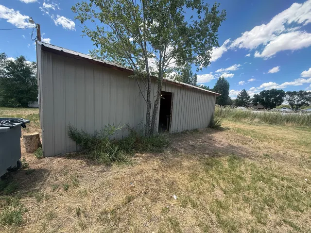 Metal-sided outbuilding with a sloped roof